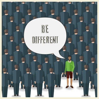 motivation quote with young man standing in a huge crowd of suits: be different